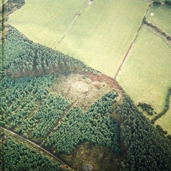 Oblique aerial view centred on the remains of the recumbent stone circle, cairn and ring cairn with cairn adjacent, taken from the NW.