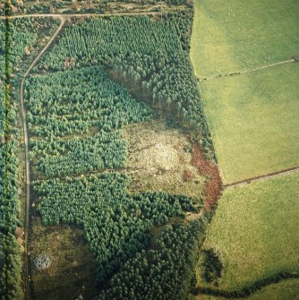 Oblique aerial view centred on the remains of the recumbent stone circle, cairn and ring cairn with cairn adjacent, taken from the WSW.