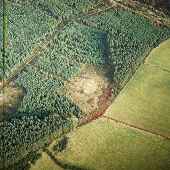 Oblique aerial view centred on the remains of the recumbent stone circle, cairn and ring cairn with cairn adjacent, taken from the SW.