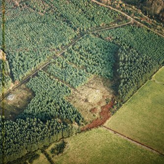 Oblique aerial view centred on the remains of the recumbent stone circle, cairn and ring cairn with cairn adjacent, taken from the SW.
