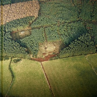 Oblique aerial view centred on the remains of the recumbent stone circle, cairn and ring cairn with cairn adjacent, taken from the S.