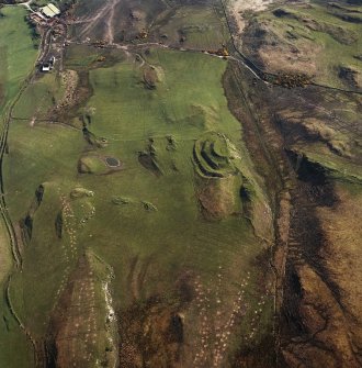 Oblique aerial view centred on the remains of the fort and rig, taken from the WSW.
