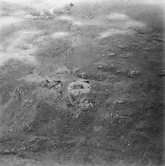 Oblique aerial view centred on the remains of the dun, taken from the ENE.