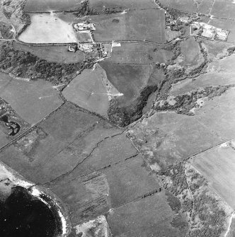 Oblique aerial view centred on the remains of the dun with the township adjacent, taken from the SSE.
