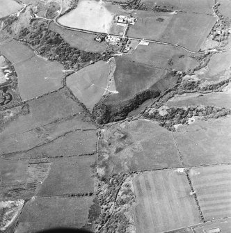 Oblique aerial view centred on the remains of the dun with the township adjacent, taken from the SE.