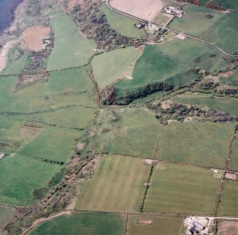 Oblique aerial view centred on the remains of the dun with the township adjacent, taken from the SE.