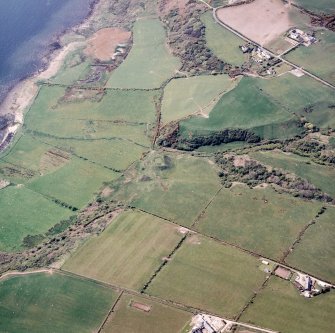 Oblique aerial view centred on the remains of the dun with the township adjacent, taken from the ESE.
