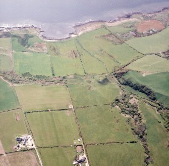 Oblique aerial view centred on the remains of the dun, taken from the ENE.