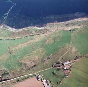Oblique aerial view centred on the remains of the rig with the remains of the forts adjacent, taken from the NW.