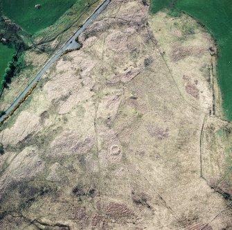 Oblique aerial view centred on the remains of the enclosure, taken from the E.