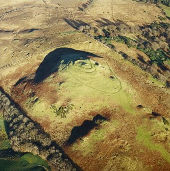 Oblique aerial view centred on the remains of the vitrified fort, taken from the SW.