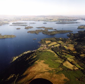 General oblique aerial view looking across the village of Luss and Loch Lomond towards Gartocharn, taken from the NW.