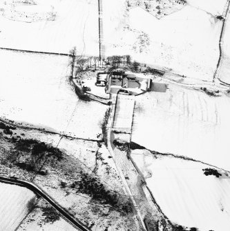Oblique aerial view centred on the farmsteading with rig adjacent, taken from the ESE
