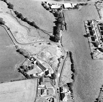 Oblique aerial view centred on the remains of the motte-and-bailey castle, taken from the W.