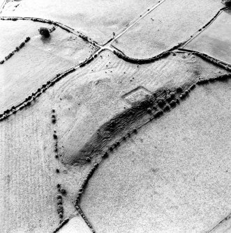 Oblique aerial view centred on the remains of the homestead moat, quarry and rig, taken from the N.
