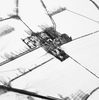 Oblique aerial view centred on the farmsteading with rig adjacent, taken from the SW