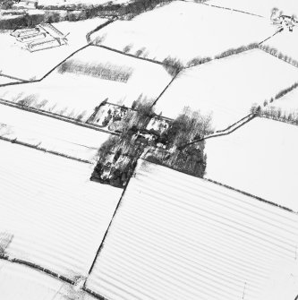 Oblique aerial view centred on the farmsteading with rig adjacent, taken from the SSE