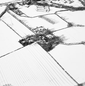 Oblique aerial view centred on the farmsteading with rig adjacent, taken from the SE