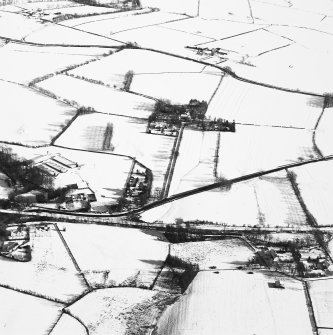 Distant oblique aerial view centred on the farmsteading with rig adjacent, taken from the WNW