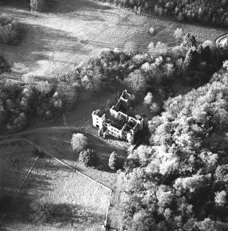 Oblique aerial view centred on the remains of the country house, taken from the E.