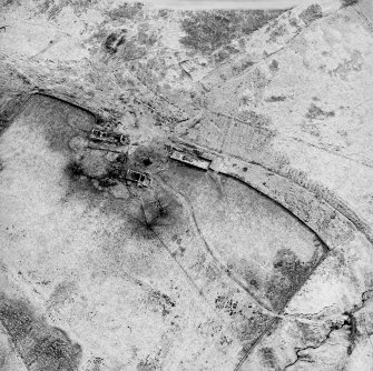 Oblique aerial view centred on the remains of the farmstead, field banks, rig and tower-house, taken from the N.
