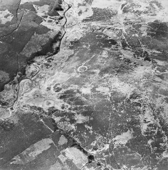 Oblique aerial view centred on the remains of sheepfolds, taken from the ESE.