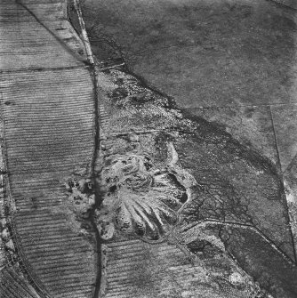 Lochend Colliery, oblique aerial view, taken from the WSW, showing Lochend Colliery coal mine in the centre of the photograph, and an area of rig with overlying plantation bank to the right.