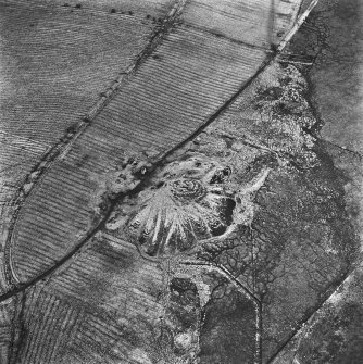 Lochend Colliery, oblique aerial view, taken from the SW, showing Lochend Colliery coal mine in the centre of the photograph, and an area of rig with overlying plantation bank to the right and centre.