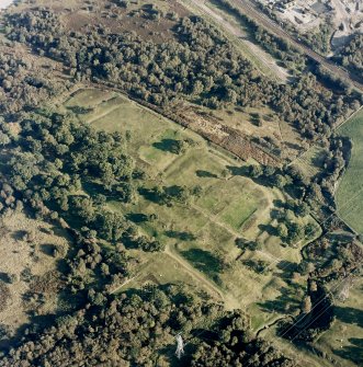 Oblique aerial view of Rough Castle centred on the remains of a Roman fort and the Antonine wall, taken from the WNW.