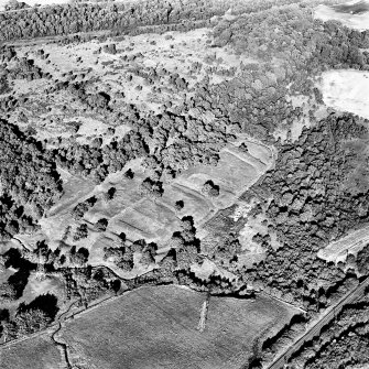 Oblique aerial view of Rough Castle centred on the remains of a Roman fort and the Antonine wall, taken from the SSW.