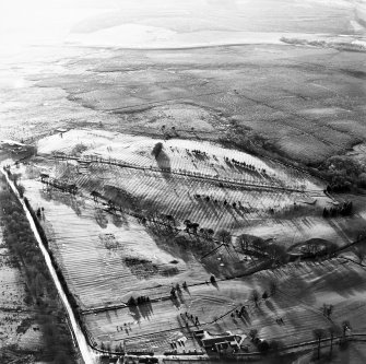 Oblique aerial view centred on the remains of rig, taken from the NE.