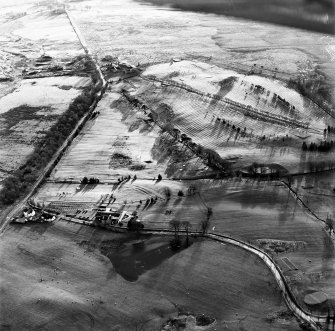 Oblique aerial view centred on the remains of rig, taken from the NNE.