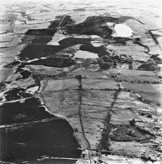 Strathavon and Nappyfaulds, oblique aerial view, taken from the W, showing Nappyfaulds farmstead and an area of rig in the bottom right-hand corner of the photograph, and Strathavon coal mines and a mineral railway in the centre right.