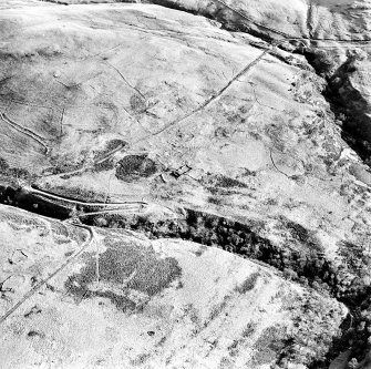 Oblique aerial view of Third and Second Inchna Burns centred on the remains of an archaeological landscape, taken from the W.