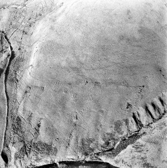 Oblique aerial photograph of shieling-huts and bank on west bank of the Second Inchna Burn (NS89NE 109) with head-dyke of neighbouring field-system (NS89NW 54.02) in background, from east.