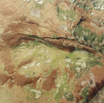 Oblique aerial view of Fossachie centred on the remains of a farmstead, field-system and rig, taken from the SW.