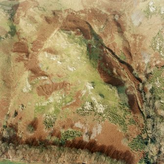 Oblique aerial view of Fossachie centred on the remains of a farmstead, field-system and rig, taken from the SSE.