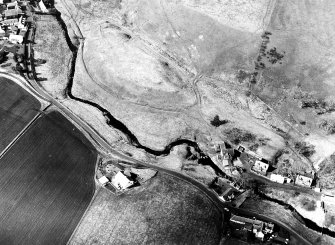 Oblique aerial view centred on the remains of the possible fort with the footbridge adjacent, taken from the SE.