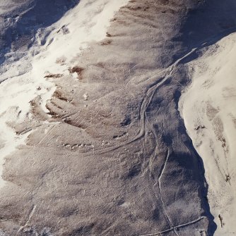 Oblique aerial view centred on the remains of the Roman Road, taken from the SE.