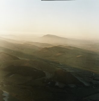 General oblique aerial view looking across Broughton village towards Tinto, taken from the E.