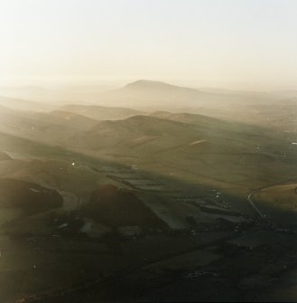 General oblique aerial view looking across Broughton village towards Tinto, taken from the E.