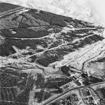 Wilsontown, oblique aerial view, taken from the ESE, showing the remains of workers' rows in the centre left of the photograph, and the ruins of the public house and shop, and a large area of bell pits, in the centre.