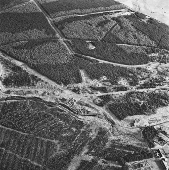 Wilsontown, oblique aerial view, taken from the E, showing the remains of workers' rows in the bottom half of the photograph, and the ruins of the public house and shop in the bottom right-hand corner. A large area of bell pits in is visible in the centre right.