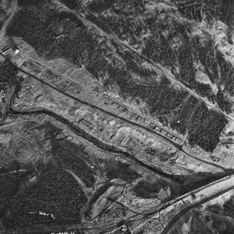 Wilsontown, oblique aerial view, taken from the SW, showing the remains of ironworks, lime kilns, coke ovens and workers' rows in the centre and bottom of the photograph, and a large area of bell pits in the centre and top right-hand corner.