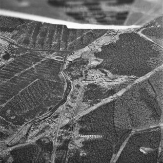 Wilsontown, oblique aerial view, taken from the NE, showing the bings of two coal mines in the centre of the photograph, and the remains a worker's row, and bell pits, at the bottom.