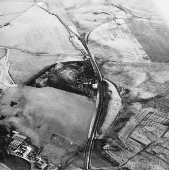 Haywood and Droveloan, oblique aerial view, taken from the W, showing Haywood village with the remains of miners' rows, and a war memorial, in the bottom right-hand corner of the photograph, a cottage and the two bings of a coal mine adjacent to the dismantled railway in the centre, and an area of rig at Droveloan cottage in the top half.