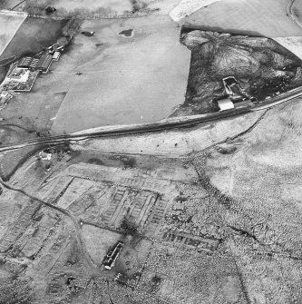 Haywood, oblique aerial view, taken from the SW, showing Haywood village with the remains of miners' rows and a farmstead in the bottom left-hand corner of the photograph, and a cottage and the two bings of a coal mine adjacent to the dismantled railway in the top right-hand corner.