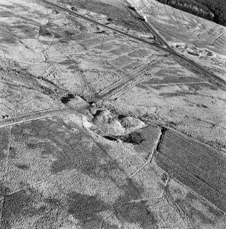 Rashiehill Muir and Miller's Moss, oblique aerial view, taken from the WSW, showing Miller's Moss road passing between a quarry and a sheepfold in the centre of the photograph, and further quarries and a trackway in the top half.