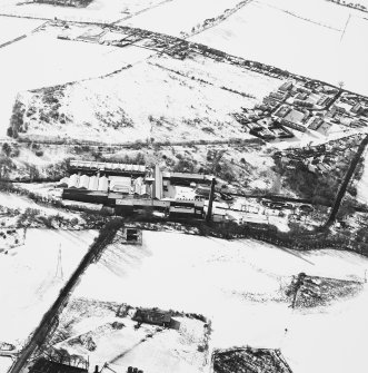 Oblique aerial view centred on the paper mill, taken from the NE.