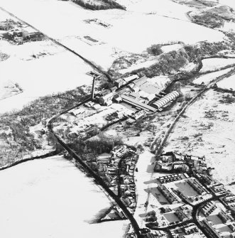 Oblique aerial view centred on the paper mill, taken from the NW.